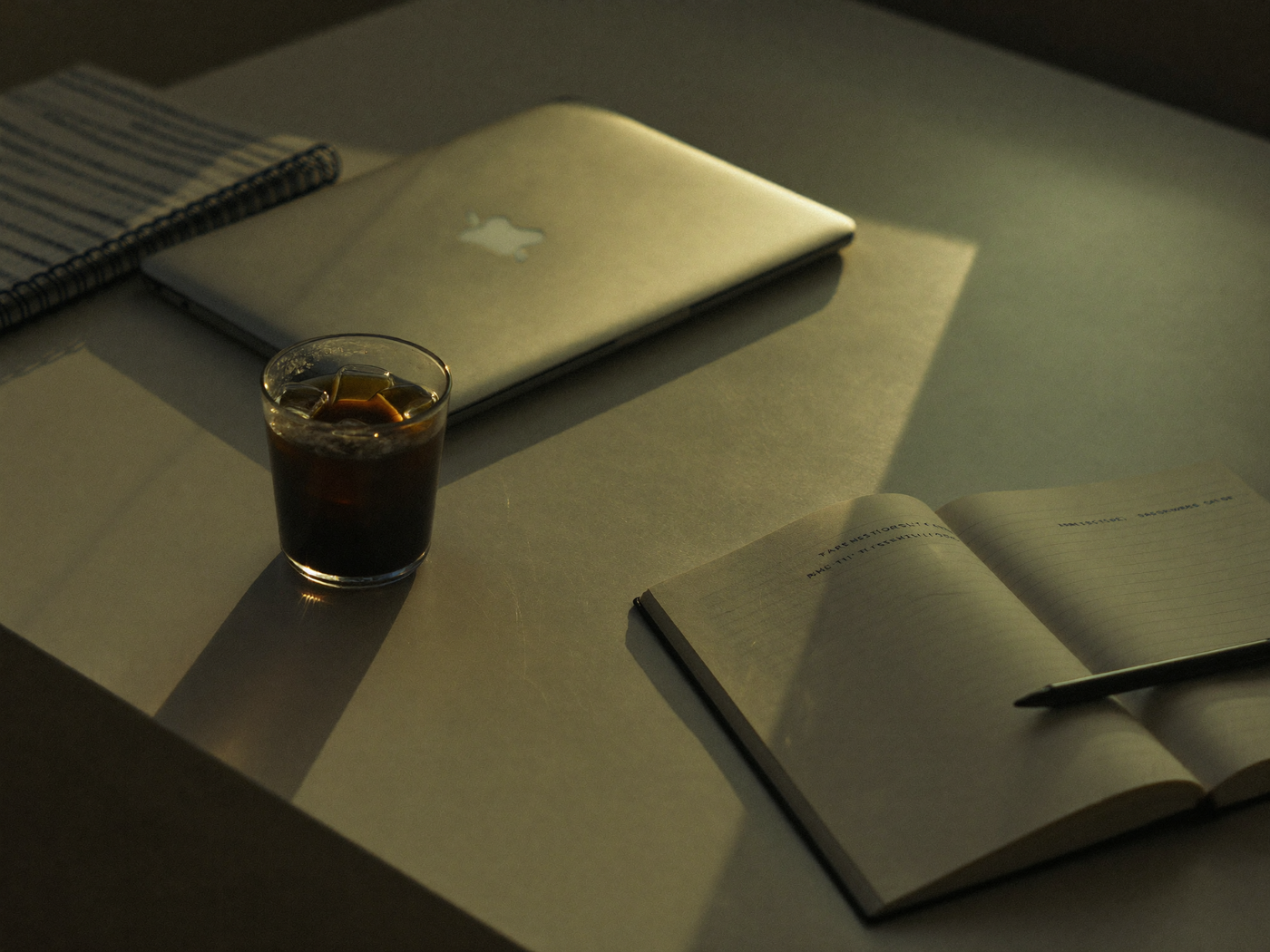 a cold cup of coffee on a desk in late afternoon light